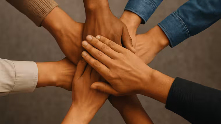 Hands placed on top of each other as a team